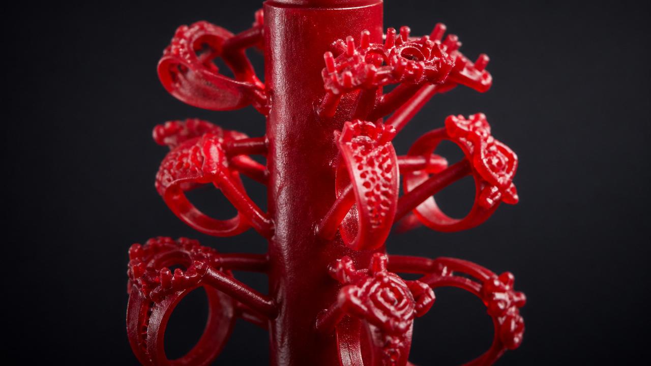 Red wax pattern tree of jewelry rings on a central sprue
